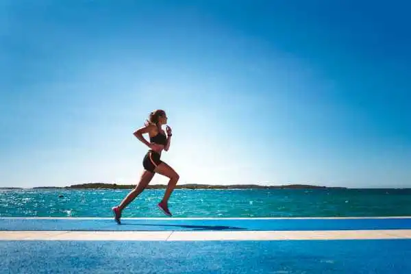 Woman running showing strong leg muscle Prestwich